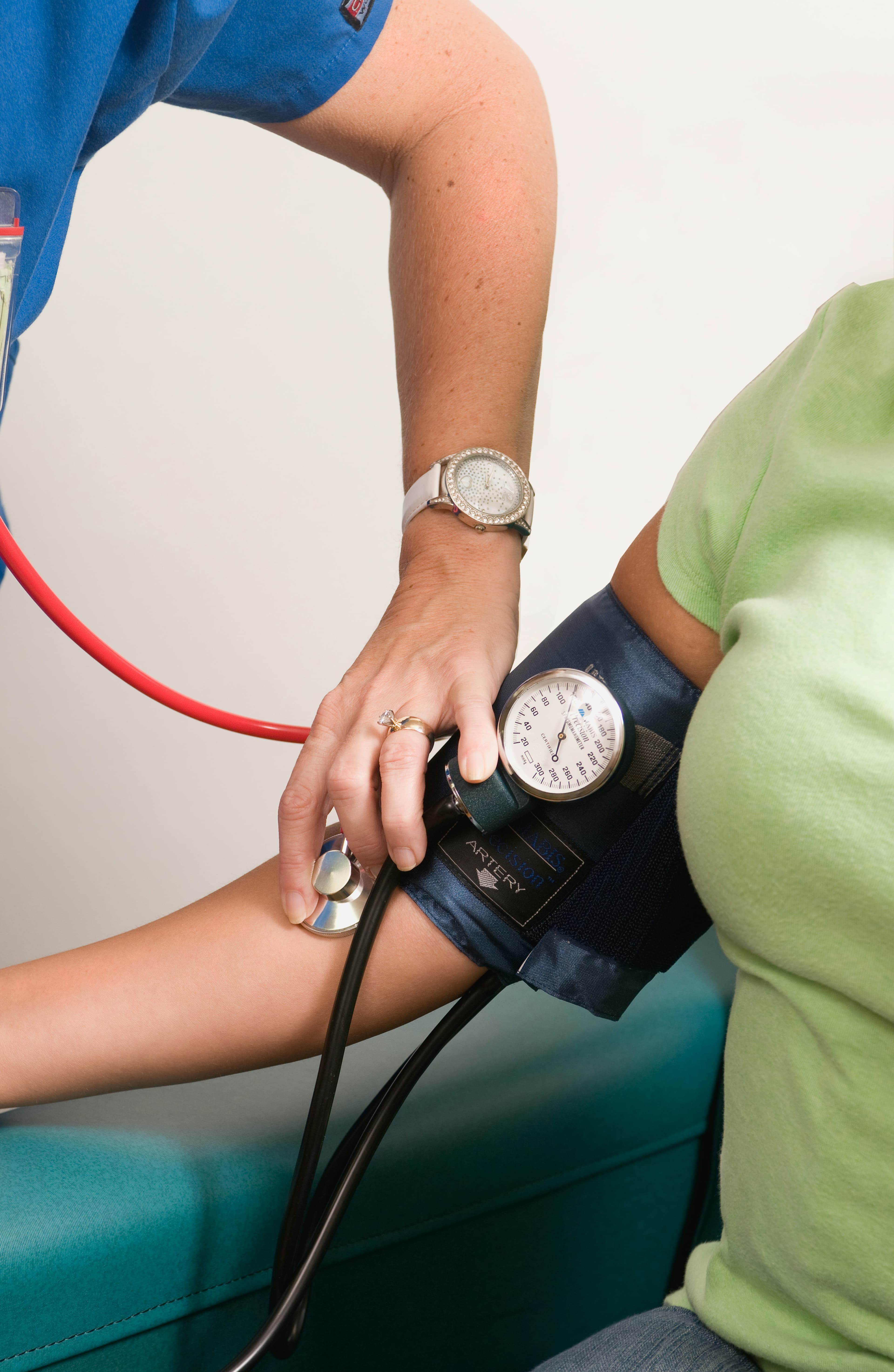 A BrevCare nurse checking a client's blood pressure at home